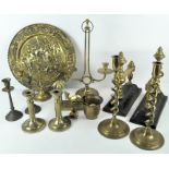 Assorted brassware, including horse brasses on leather mounts and various candlesticks,