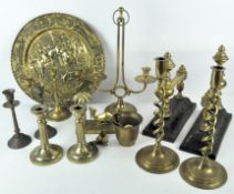 Assorted brassware, including horse brasses on leather mounts and various candlesticks,
