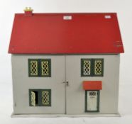 A 1960s wooden mounted dolls house with metal mounted windows and front door,