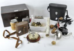 An assortment of collectables, including two pairs of binoculars and a vintage pencil sharpener