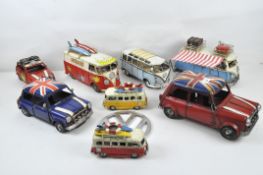 A collection of display VW vans and Mini cars, and a VW shield,