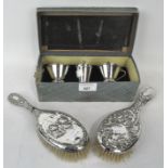 Two silver hair brushes with embossed Reynolds Angels decoration with a silver plated cruet