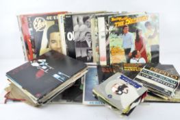 A collection of records, including The Best of Glen Miller, Simon & Garfunkel,
