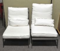 Two contemporary metal frame outdoor lounge chairs with white cushion covers,