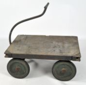 A vintage Thompsons trolley with green painted wheels, with metal plaque reading: Edwd.