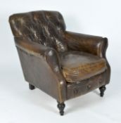 An early 20th century button back leather armchair, raised upon turned supports,