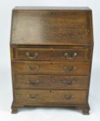 An early 20th century oak bureau, the drop front opening to reveal fitted interior,