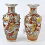 A pair of Japanese Satsuma-style vases, decorated with figures wearing traditional costumes,