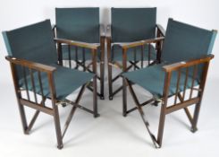A set of four folding director style chairs with dark green canvas seats and backs,
