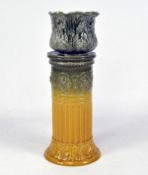 An early 20th century jardiniere stand with mustard and green glaze with raised pattern of shells