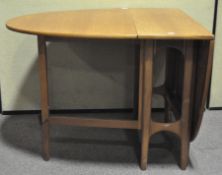A large oval mid-century folding table,