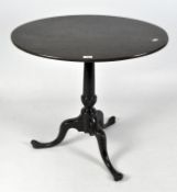 A late 19th century, dark stained oval tilt top table on a tripod support,