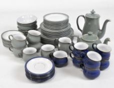 Two Denby part tea sets in dark blue and olive green, including cups, plates, tea and coffee pot,