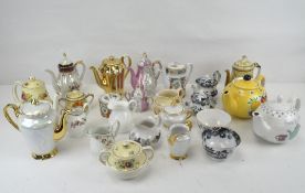 A selection of tea and coffee pots, some with matching jugs and sugar bowls,