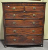 A large Victorian bow fronted mahogany chest of drawers with ring handles, on bun feet,