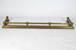 A yellow metal fire fender with continuous railing supported by spheres,