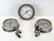 Two vintage circular water pressure valves, together with a similar example