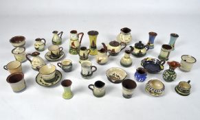 A collection of Devonshire Torquay ware, including pieces by "Watcombe"