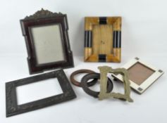 A selection of photograph frames, including a bone inlaid example and numerous others,