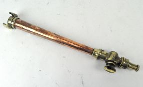 A vintage copper and brass French fire hose nozzle,