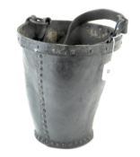 A rustic black leather bucket, with metal pins and rim,