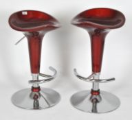 Two Retro red bar stools,