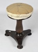 An early 20th century adjustable round stool on a tripod foot,