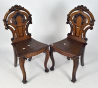 A pair of Victorian stained oak hall chairs,