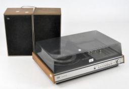 A teak cased ITT KA2015 record deck with perspex lid and a pair of ITT LS30 speakers