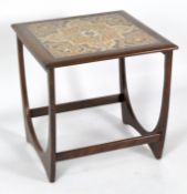 A G-Plan tile top side table inset with four brown and orange patterned tiles,