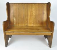 A high backed, winged settle with panel back,