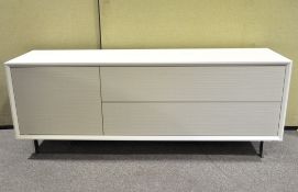 A modern low sideboard media unit in pale grey