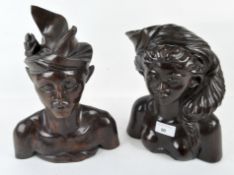 Two 20th century Asian carved hardwood busts, depicting a male and female,