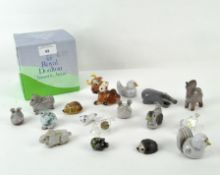 A collection of miniature pottery animals, including birds, a rabbit, horse, hedgehog and more,