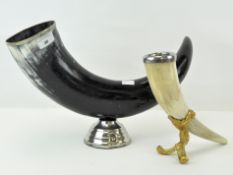 Two mounted cow horns, one large black example on a metal base, length 44cm,