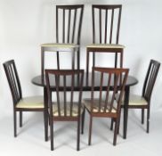 A contemporary extending dining table and six matching chairs,