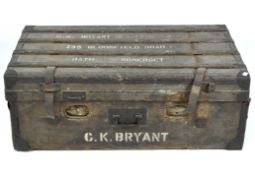 An antique travelling trunk, the wooden frame covered in fabric and bound with metal and leather,