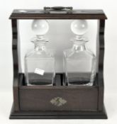 A contemporary two-bottle glass tantalus, with original key,