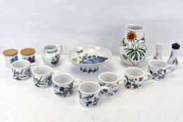 A group of Portmeirion ceramics, cups, a vase, dish, jug and shakers, and a pair of lidded pots,