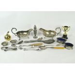 A collection of assorted silver plated wares, including two sauce boats and a caddy spoon,