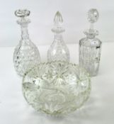 A selection of cut glassware including 3 decanters,a large bowl with zig-zag rim, diameter 26cm,