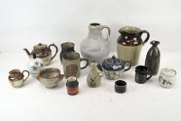 An enamelled stoneware teapot, together with assorted stoneware pots, jugs and mugs,