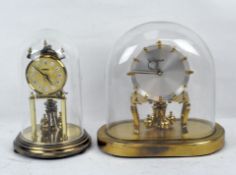 Two domed brass anniversary Kundo clocks, heights with domes 23.5cm and 22cm