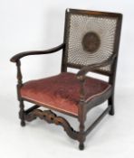 A bergère chair, with pink velvet upholstery and rattan back,