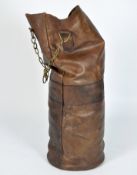 A contemporary antique style brown leather punch bag with brass hanging chain,