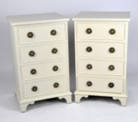 A pair of white painted bedside chests of drawers, each comprising four drawers,