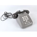 A grey vintage PO telephone,