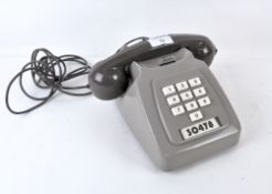A grey vintage PO telephone,