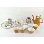 A collection of Poole pottery, including teapot, three tea cups and a sugar bowl,