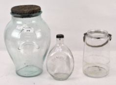 Three vintage glass bottles and jars, one being a "Dimple" whisky bottle, max.